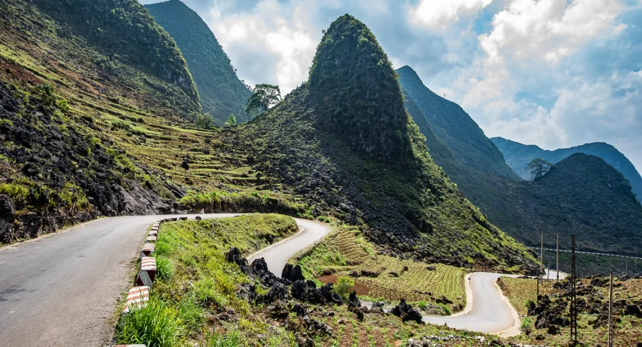 Mountain roads winding through the green landscape of Ha Giang, Vietnam